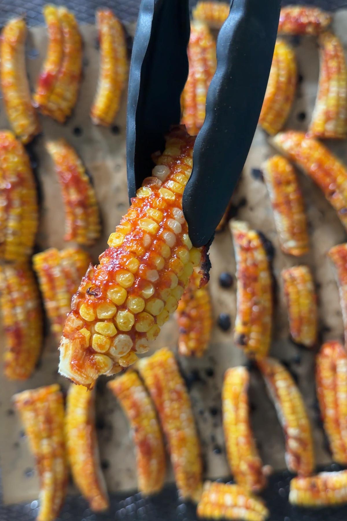Cooked air fryer corn ribs with sticky gochujang glaze.