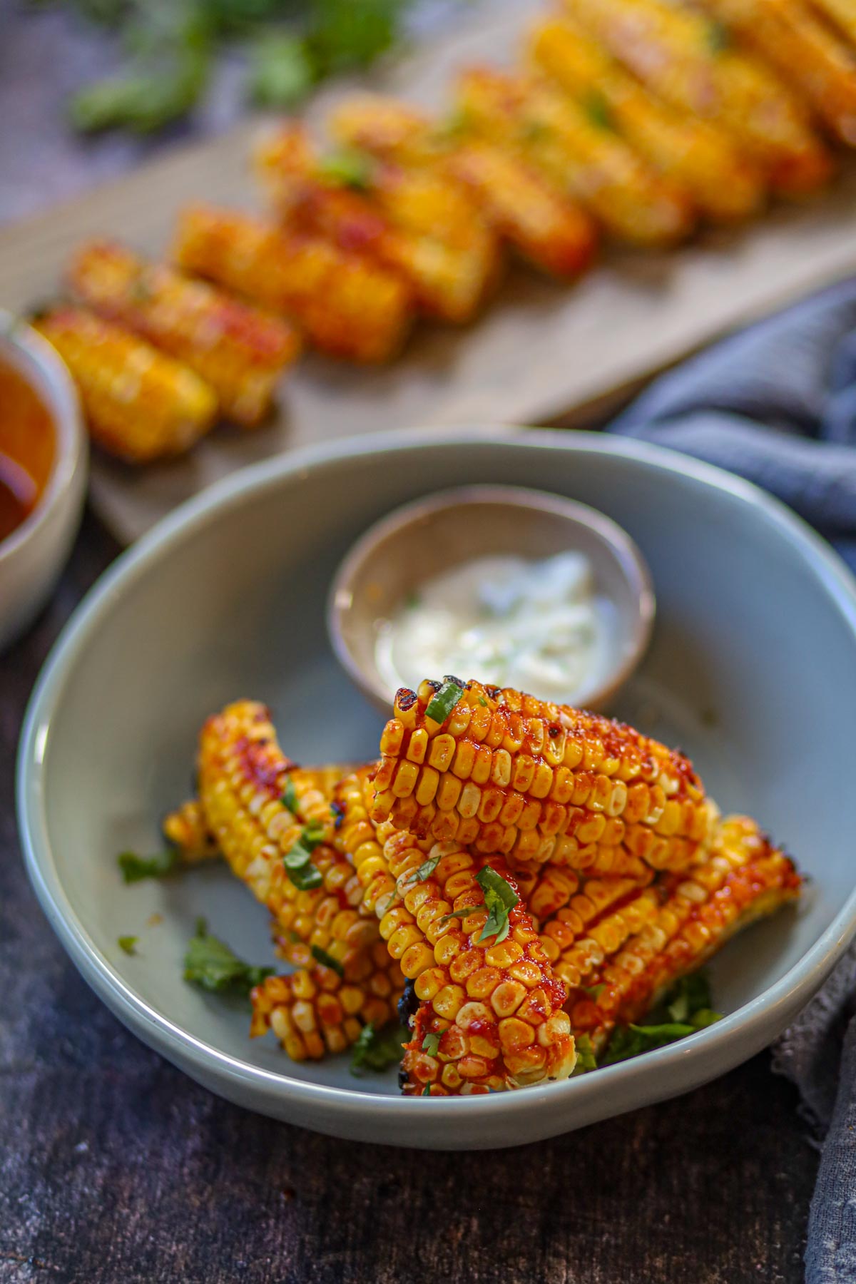 Air fryer gochujang corn ribs served with garlic yogurt dip.