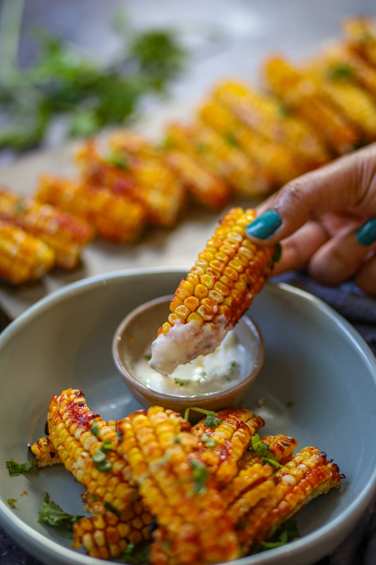 Air fryer corn rib dipped in garlic yogurt sauce.