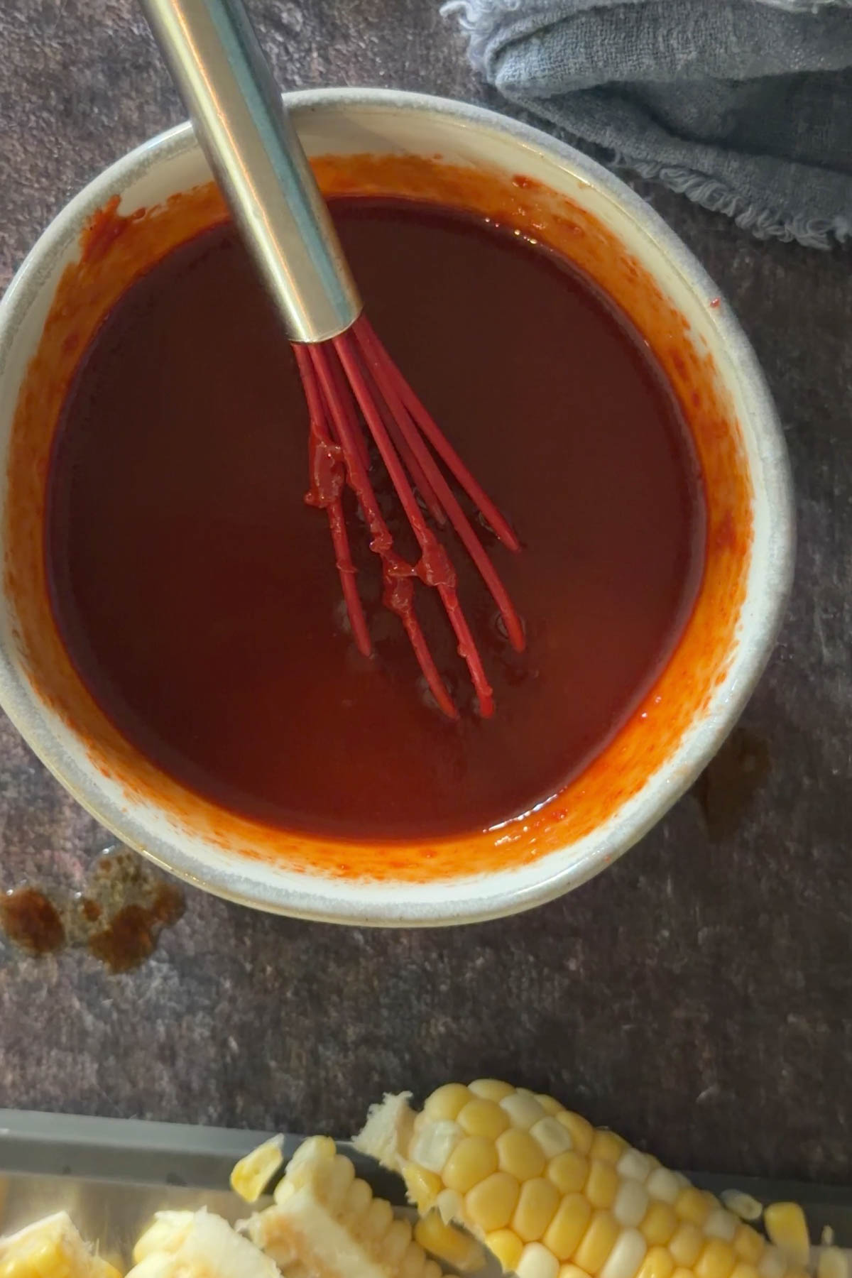 Gochujang glaze mixed in a bowl for air fryer corn ribs.