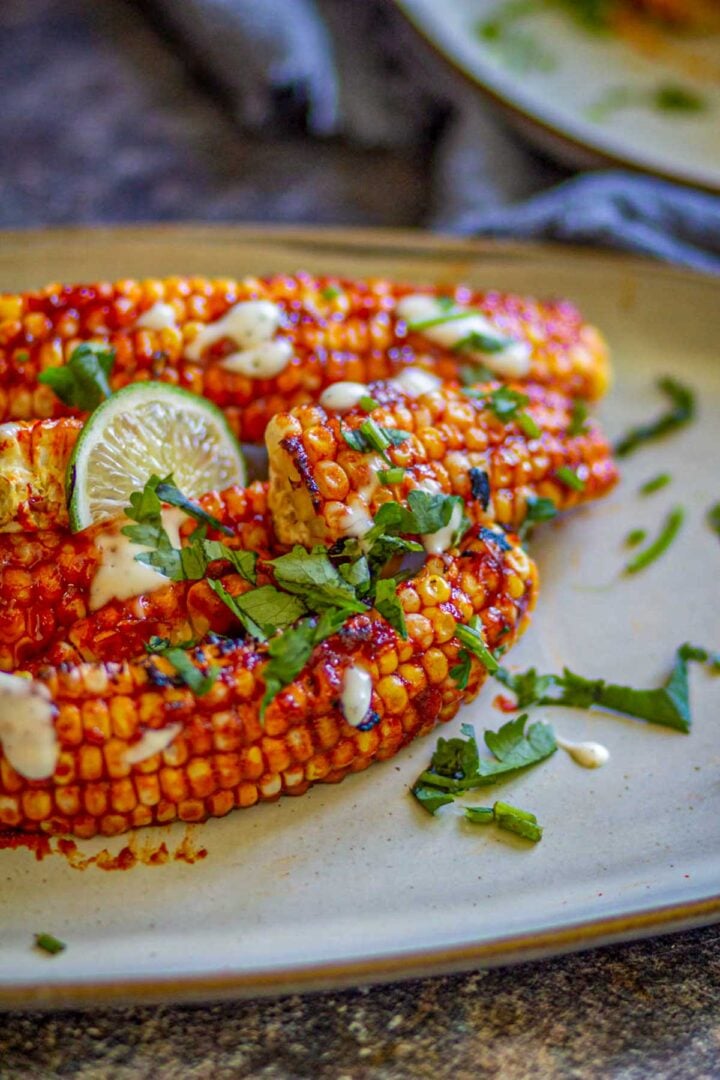 Sticky gochujang air fryer corn ribs with cilantro and lime.