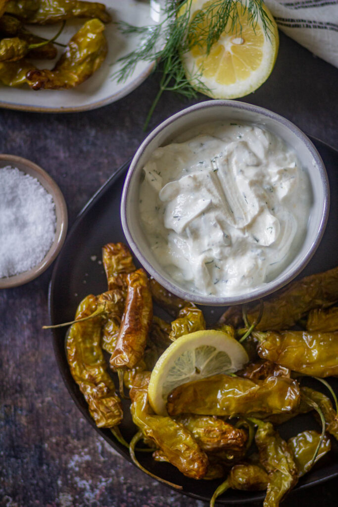 shishito peppers in a black plate with Greek Yogurt Ranch