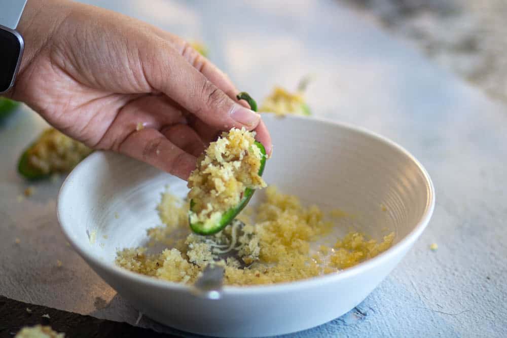 top the jalapenos with breadcrumbs mixture