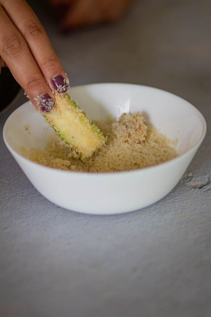 bread the zucchinis with breadcrumbs mix