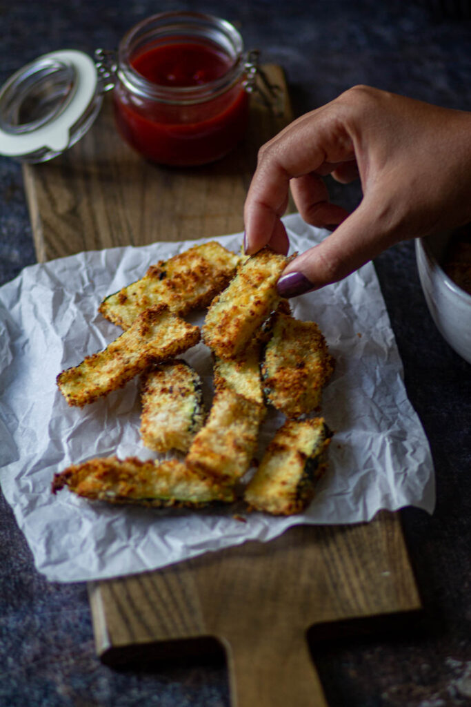 serving zucchini fries on the parchment paper