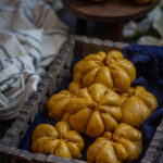 pumpkin dinner rolls on a grey tray