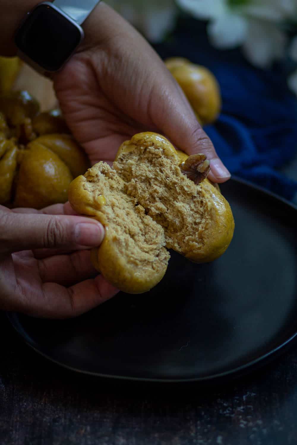 Pumpkin dinner rolls broken from the middle.