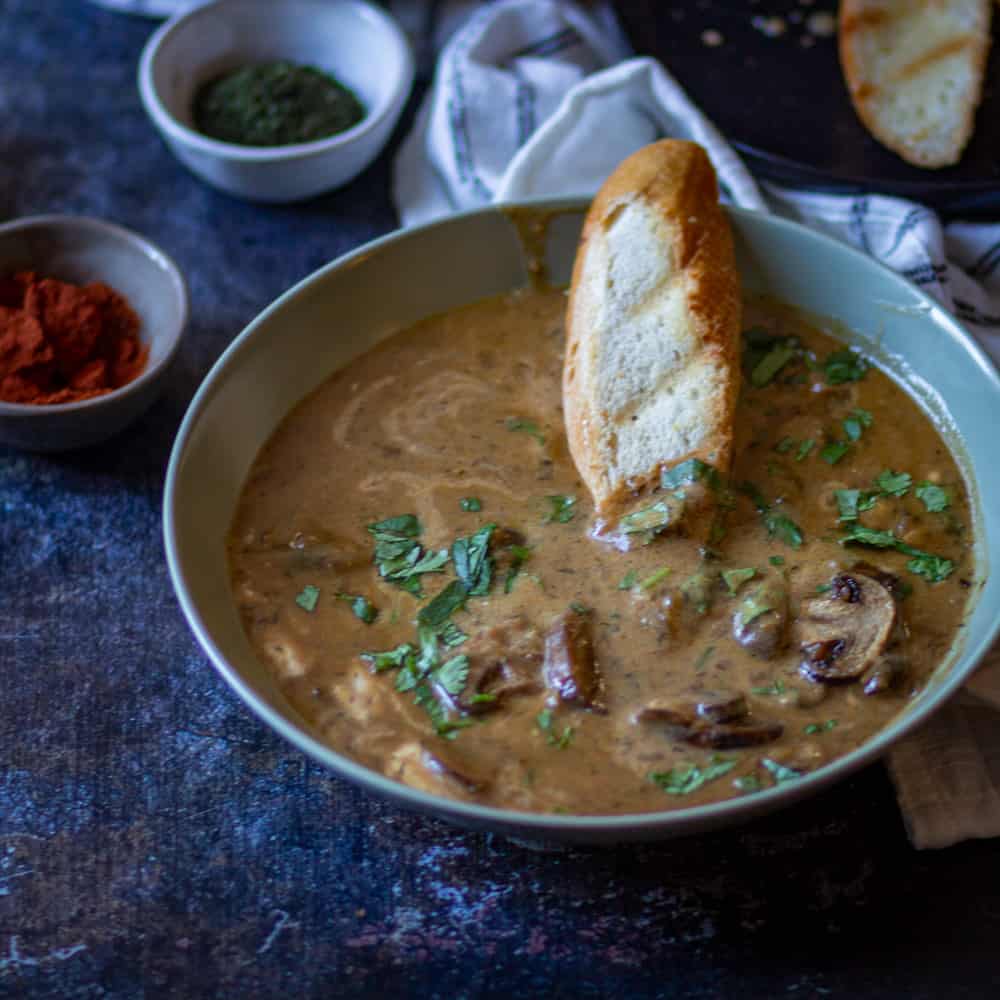 Hungarian Mushroom Soup in a big bowl with crusty bread