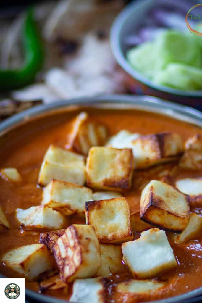 Image of shahi paneer recipe topped with air fried paneer cubes.