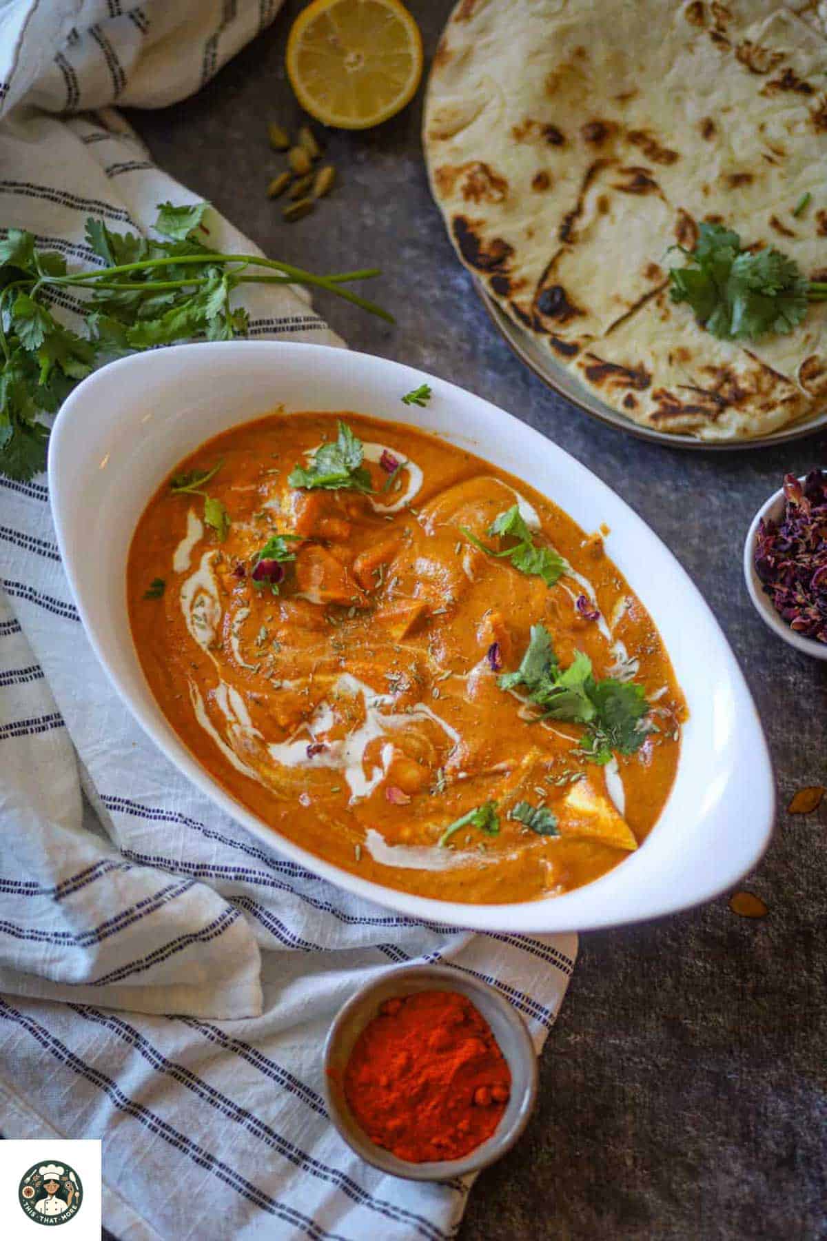 Image of shahi paneer served in a white bowl and garnished with cilantro and cream.