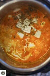 Image of curry topped with paneer, kasuri methi, and cream.