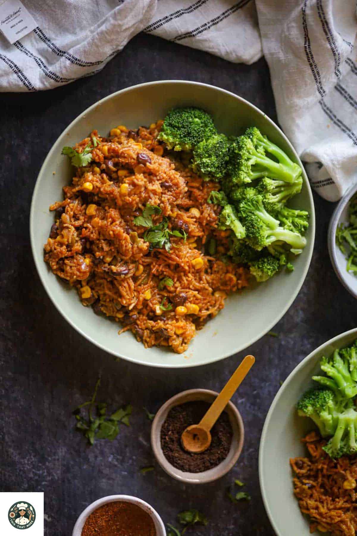 Image of Mexican Rice served in a green bowl with steamed broccoli.