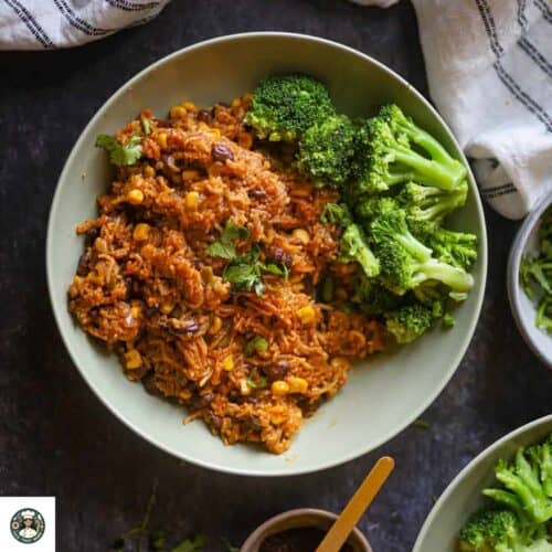 Overshot image of vegetarian mexican rice served with steamed broccoli in a green bowl.