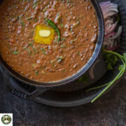 Close-up of creamy instant pot dal makhani with melted butter on top.