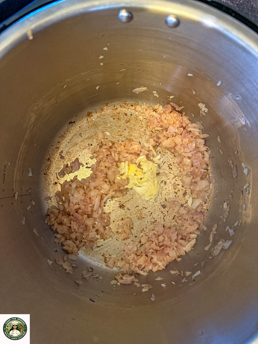 Sautéing onions and ginger in the Instant Pot for dal makhani.