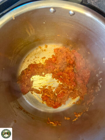 Tomato-onion masala cooking in Instant Pot for dal makhani.