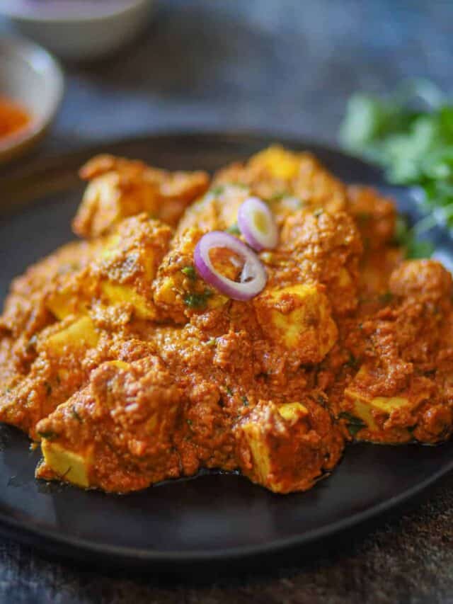 Achari Paneer garnished with cilantro.