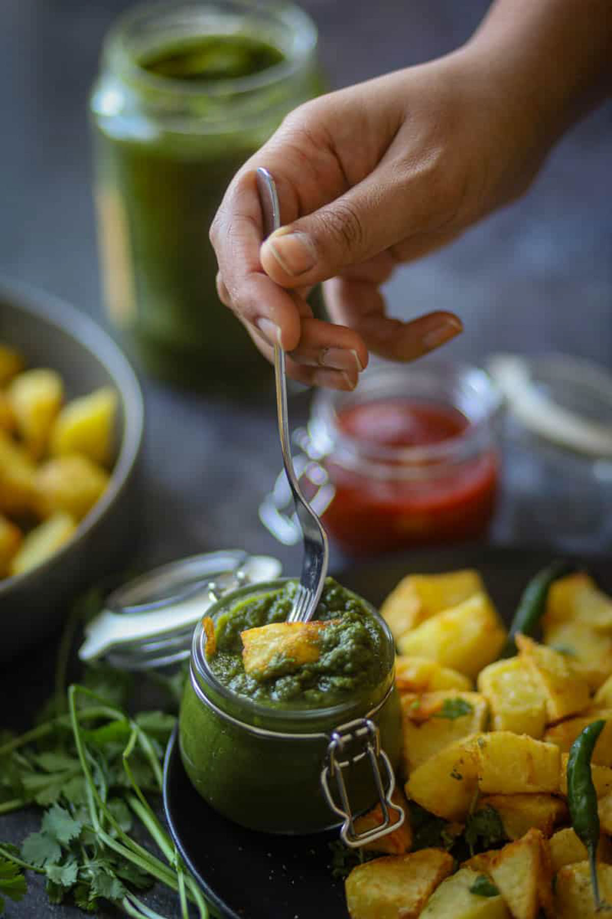 Green chutney served with roasted potatoes.
