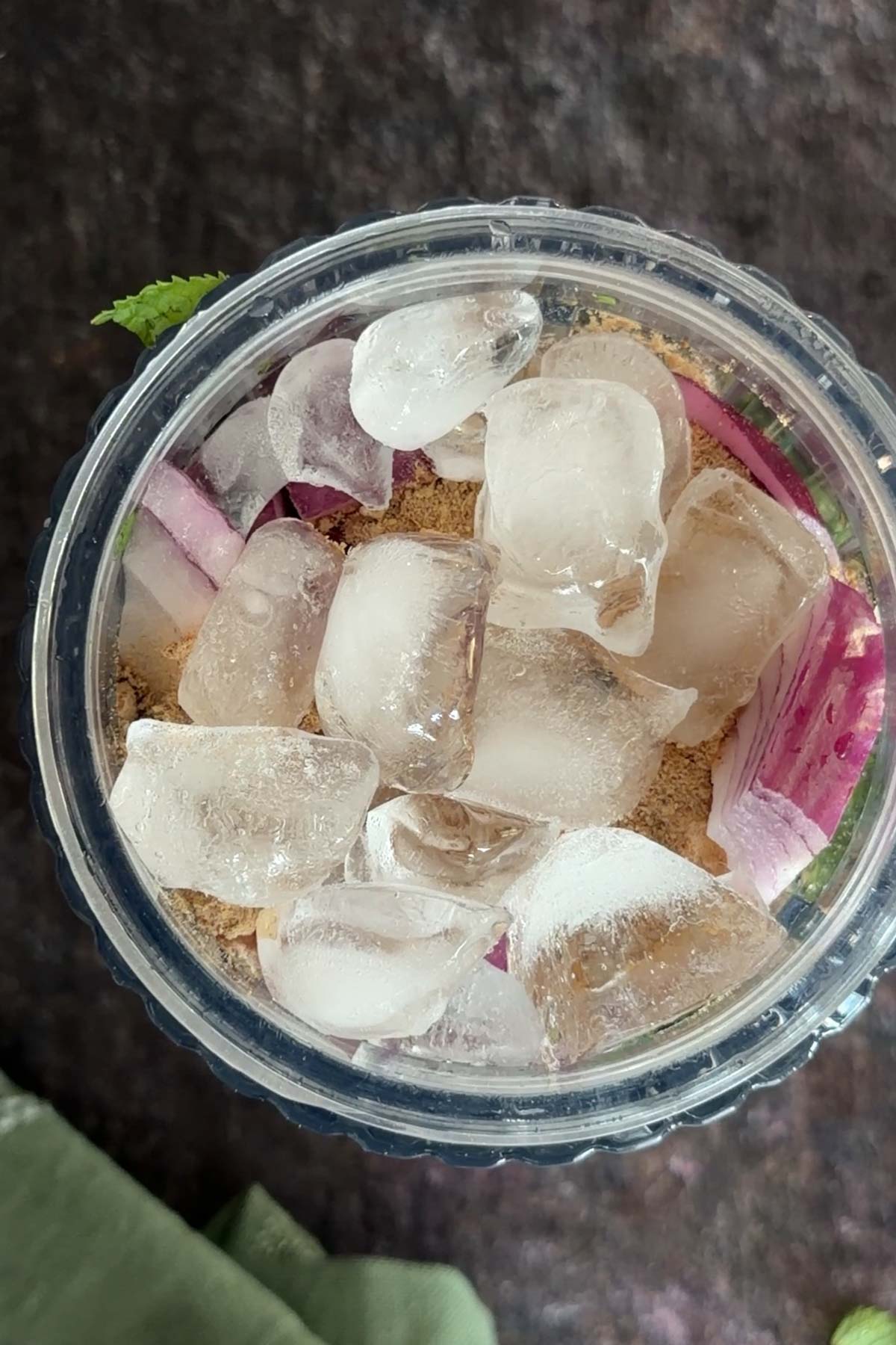 Ice cubes added to green chutney ingredients before blending.