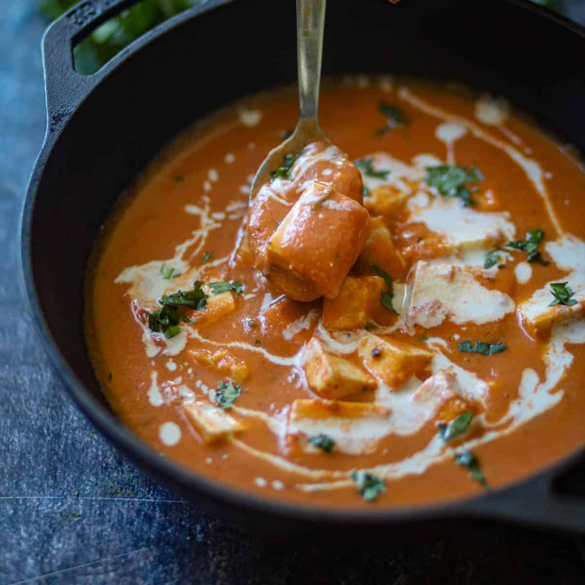 taking a spoon full from black wok.