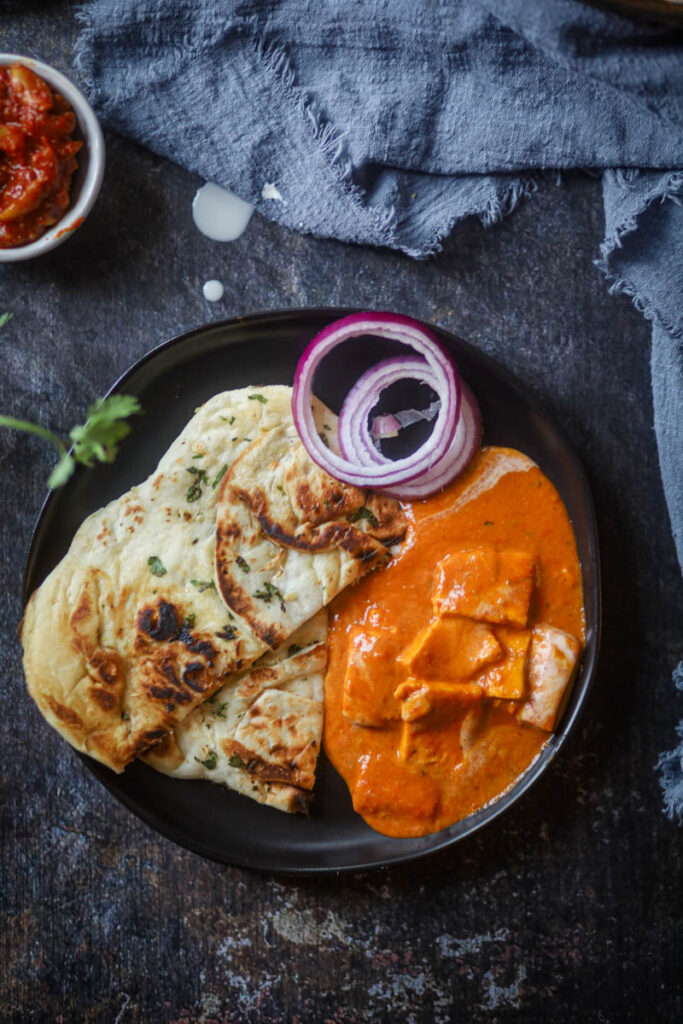 Served butter paneer masala with naan.
