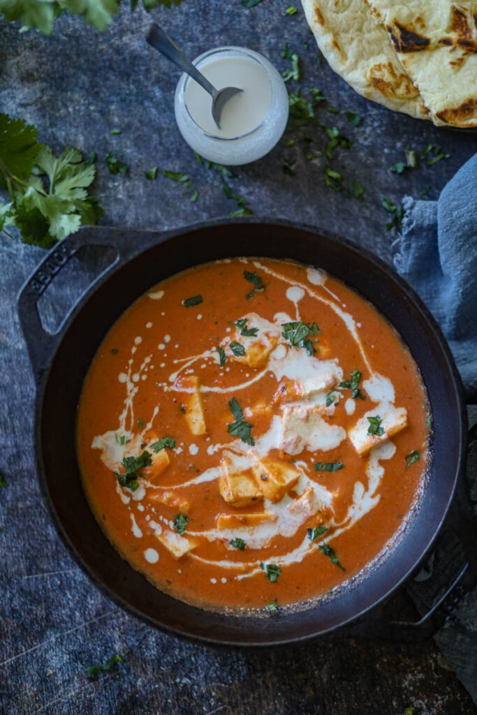Garnish Butter Paneer Masala with cream and cilantro.