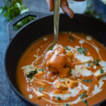 Taking a big spoon full of paneer butter masala.