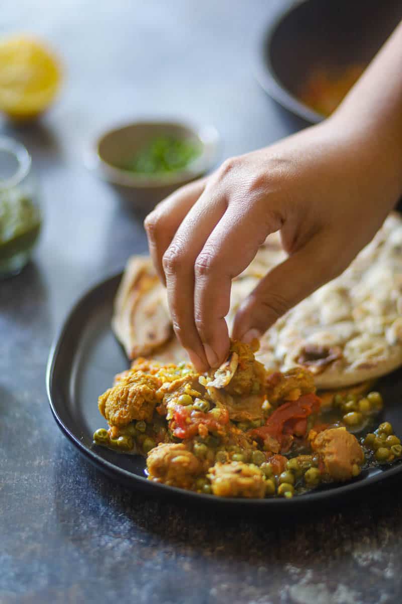 taking a bite of soya chunks curry.