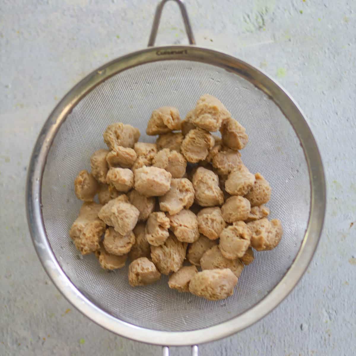 Strain the liquid from the boiled soya chunks.