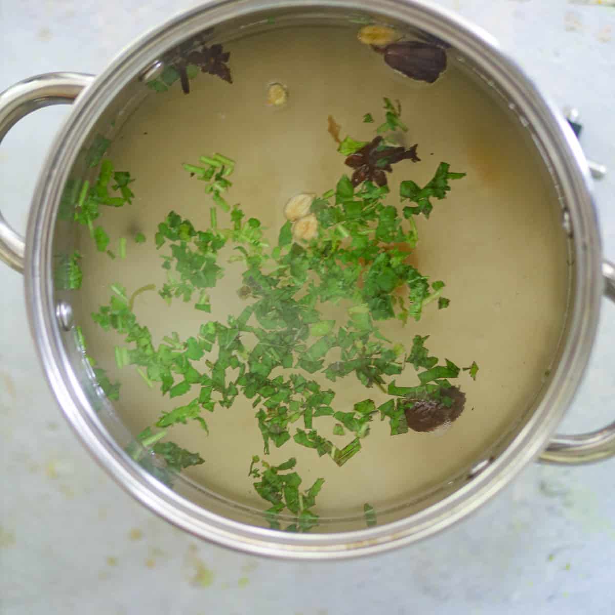 Boil rice in the water with whole spices.