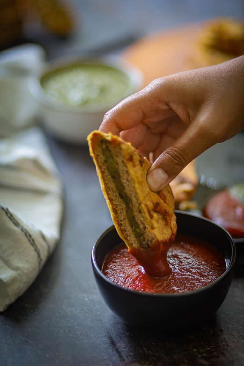 Bread Pakora dipped in the sauce.