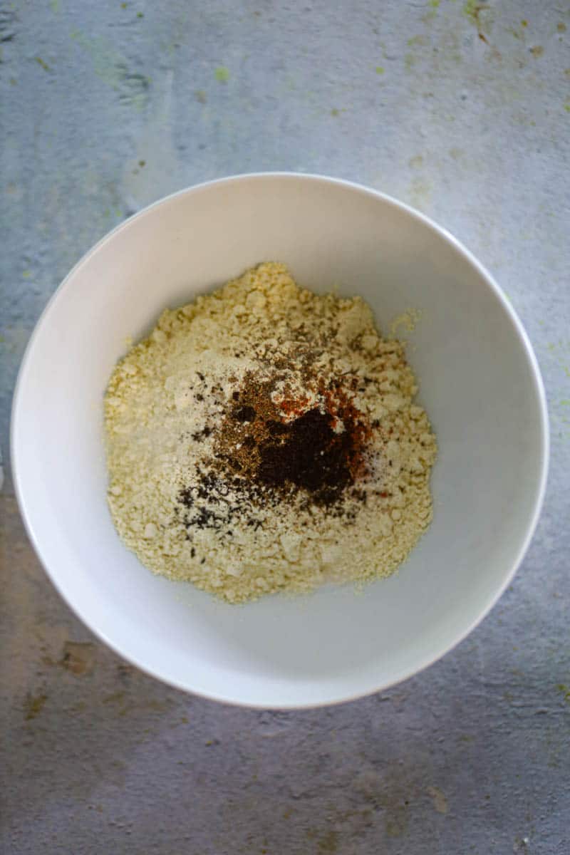 Add gram flour and spices in a bowl.