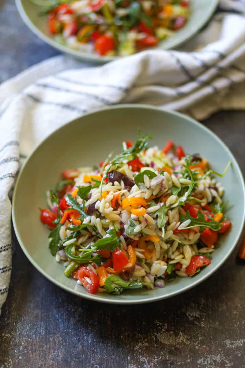 Orzo Pasta Salad garnished with some feta cheese.