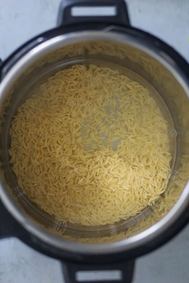 Add water and orzo in the instant pot & pressure cook.