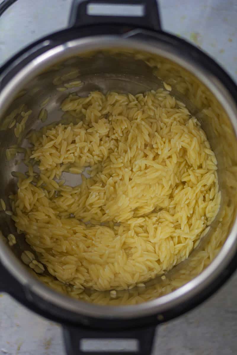 Strain the liquid and soak the orzo in water, to avoid cooking process.