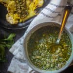 Cilantro Chimihcurri Sauce served in a white bowl with spoon.