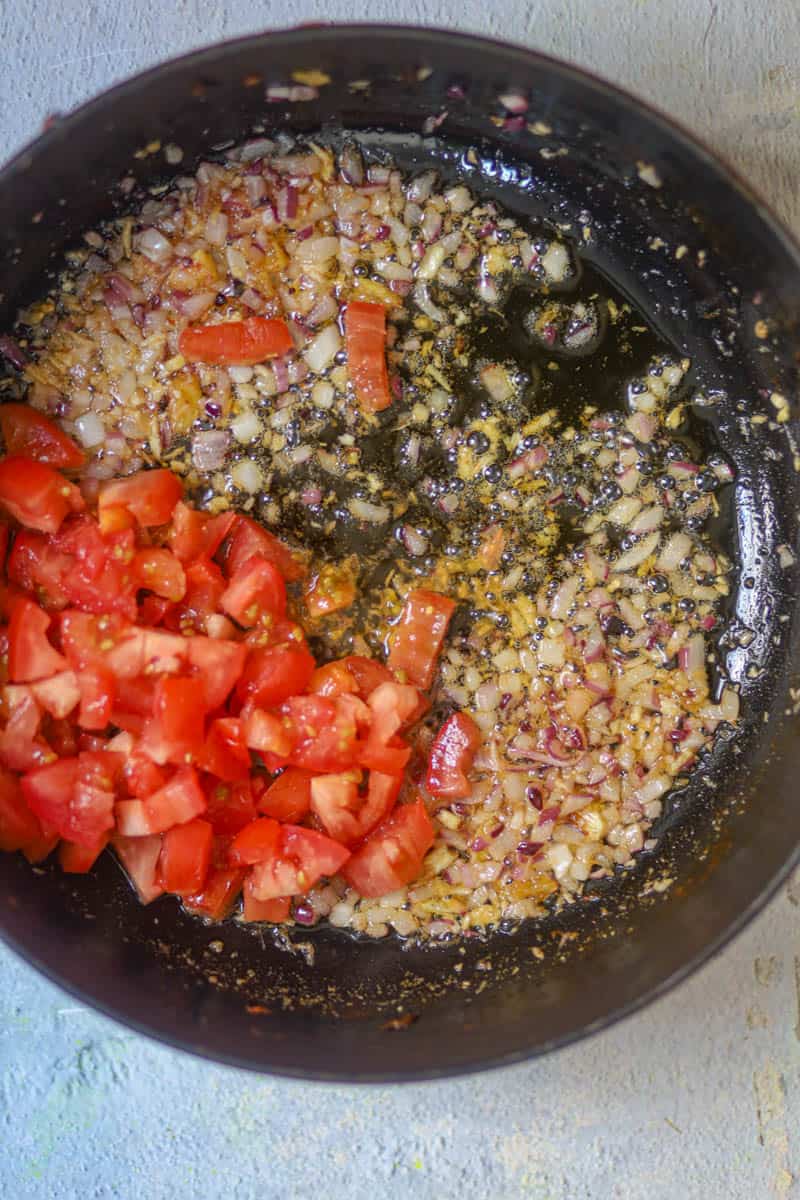 Then add tomatoes and cook until soft & mushy.