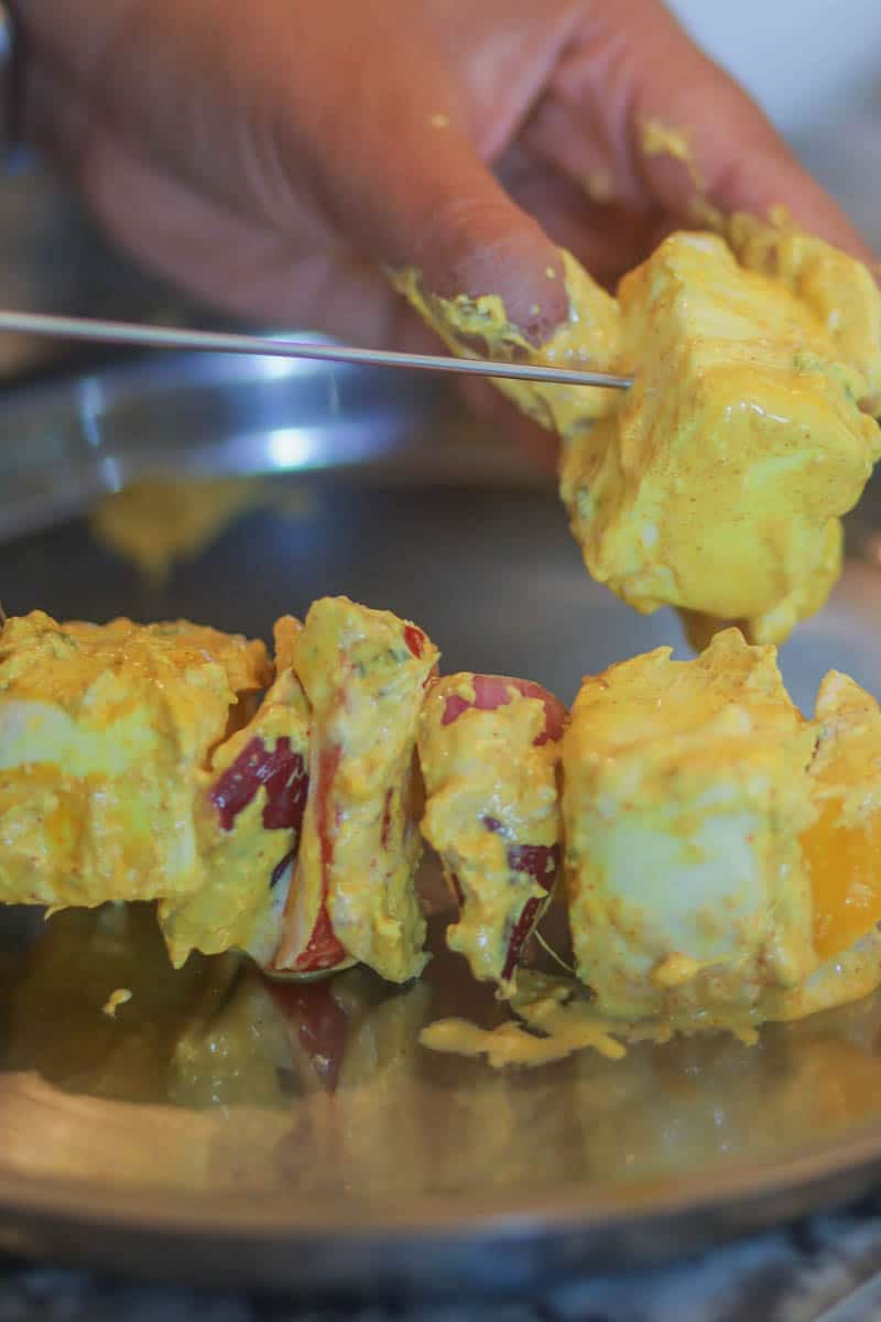 Thread paneer tikka in the skewers after marination.