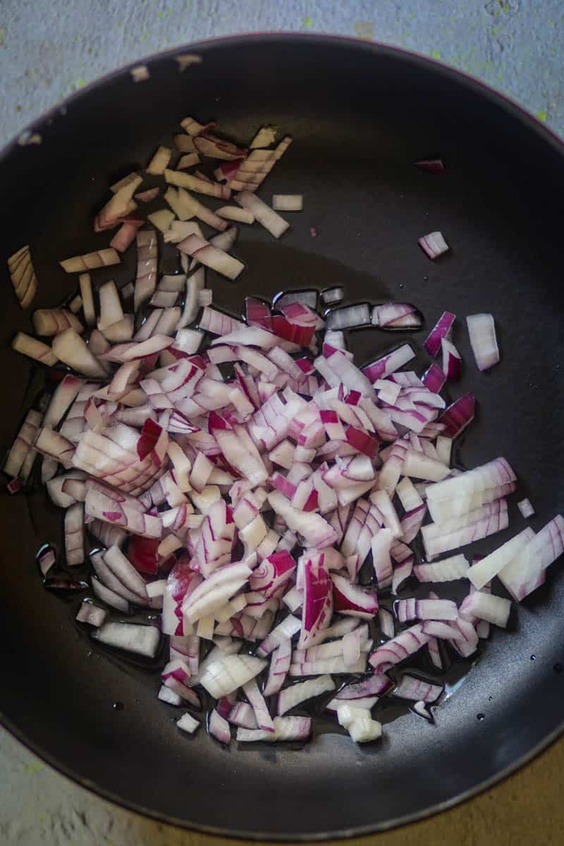 Fry onions in a pan.