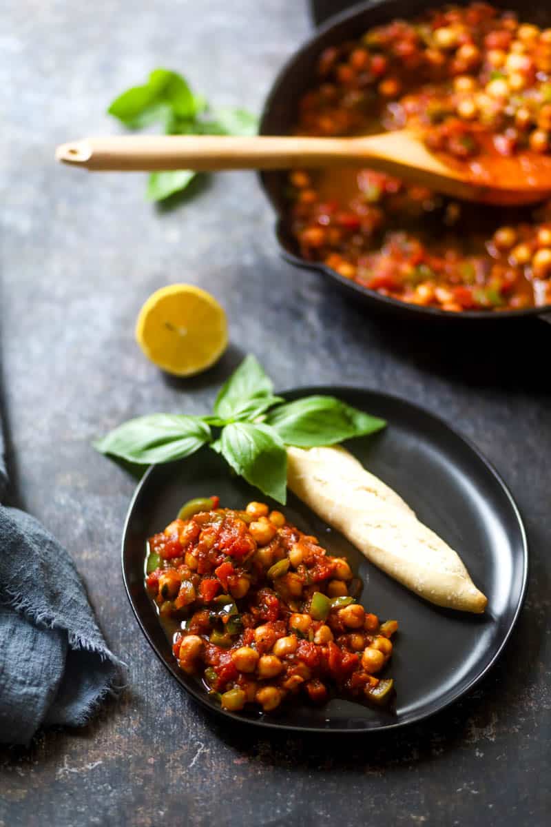 Served vegan shakshuka with bread on a black palte.