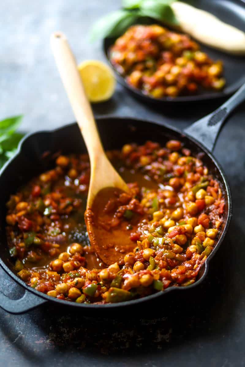 Vegan Shakshuka with chickpeas garnished with basil leaves.