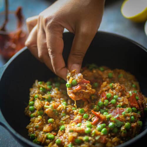 Taking a bite of roti and baingan bharta.