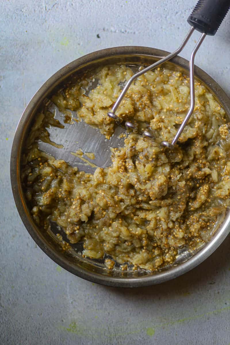 Mash the eggplant using a potato masher or fork.