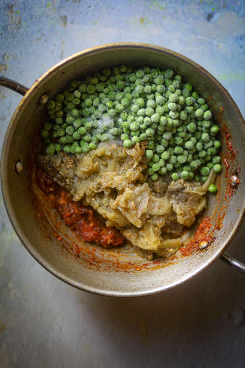Add mashed eggplant and peas.