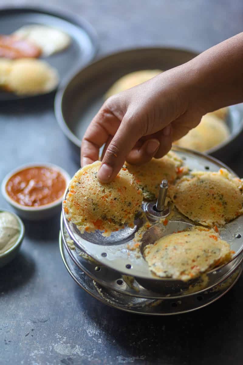 Remove the idli from the idli molds.