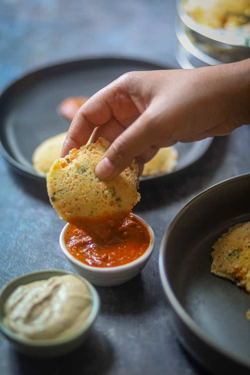 Dipping rava idli in chutney.