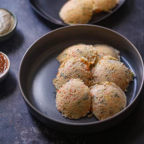 Rava Idli lined on a gray plate.
