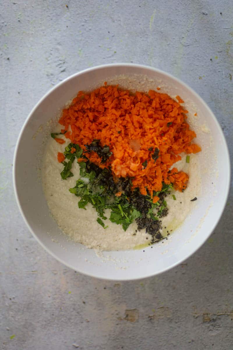 Add veggies, tempering, and salt in the batter.