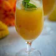 Peach mango iced tea served over ice with fresh mint.
