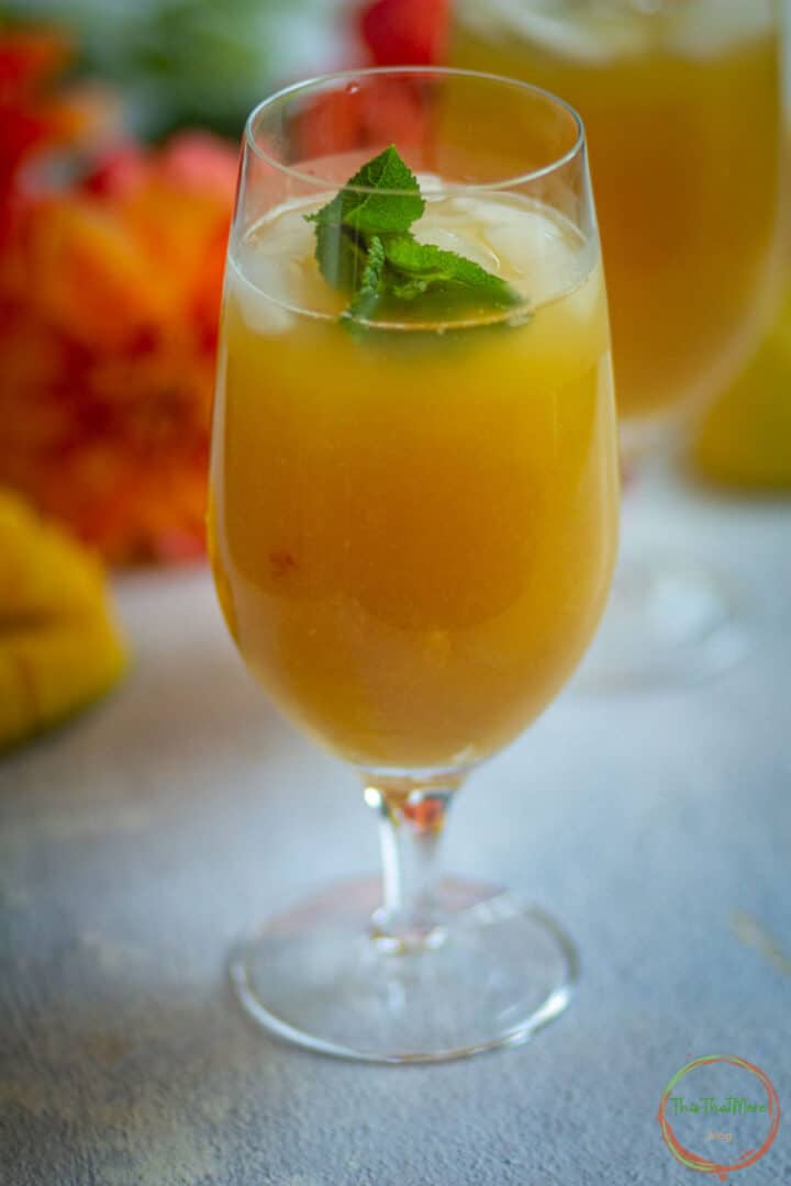 Peach mango iced tea served over ice with fresh mint.